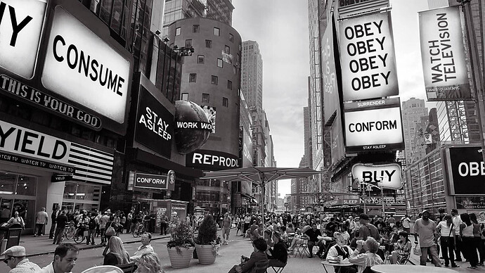 A (non-)fictional Times Square filled with billboards signalling "OBEY", "CONFORM", "CONSUME", "WORK", "REPRODUCE", "WATCH TELEVISION". Taken from the movie They Live (1988).
